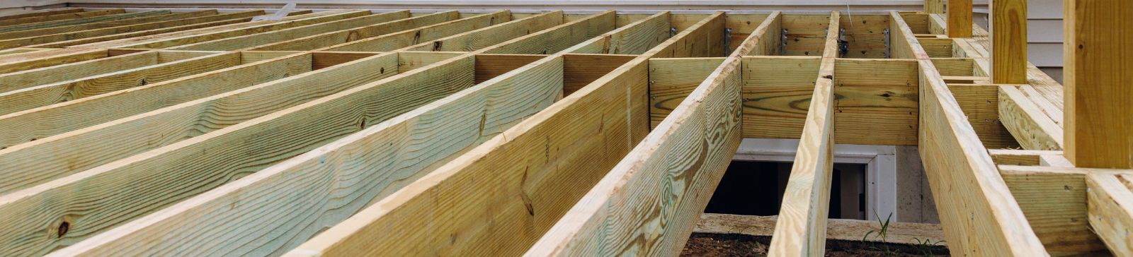 Wide shot of backyard deck construction in Santa Fe Springs, highlighting the robust wooden frame and level layout.